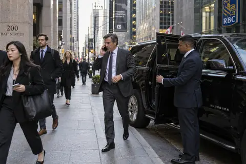 Executive stepping out of a black Suburban on Bay Street