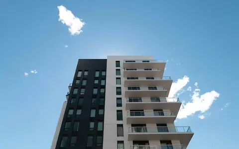 Modern condo building in Markham against a blue sky