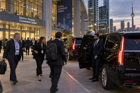 Black SUVs lined up for delegates outside a Toronto convention centre