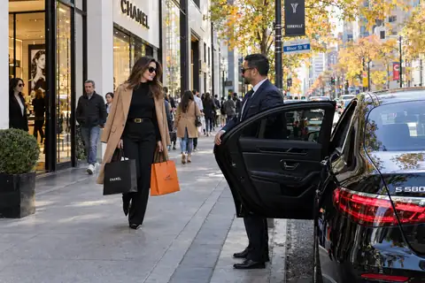 Chauffeur holding the door of a black S-Class on Bloor Street in Yorkville
