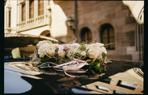Wedding flowers on the roof of a black car